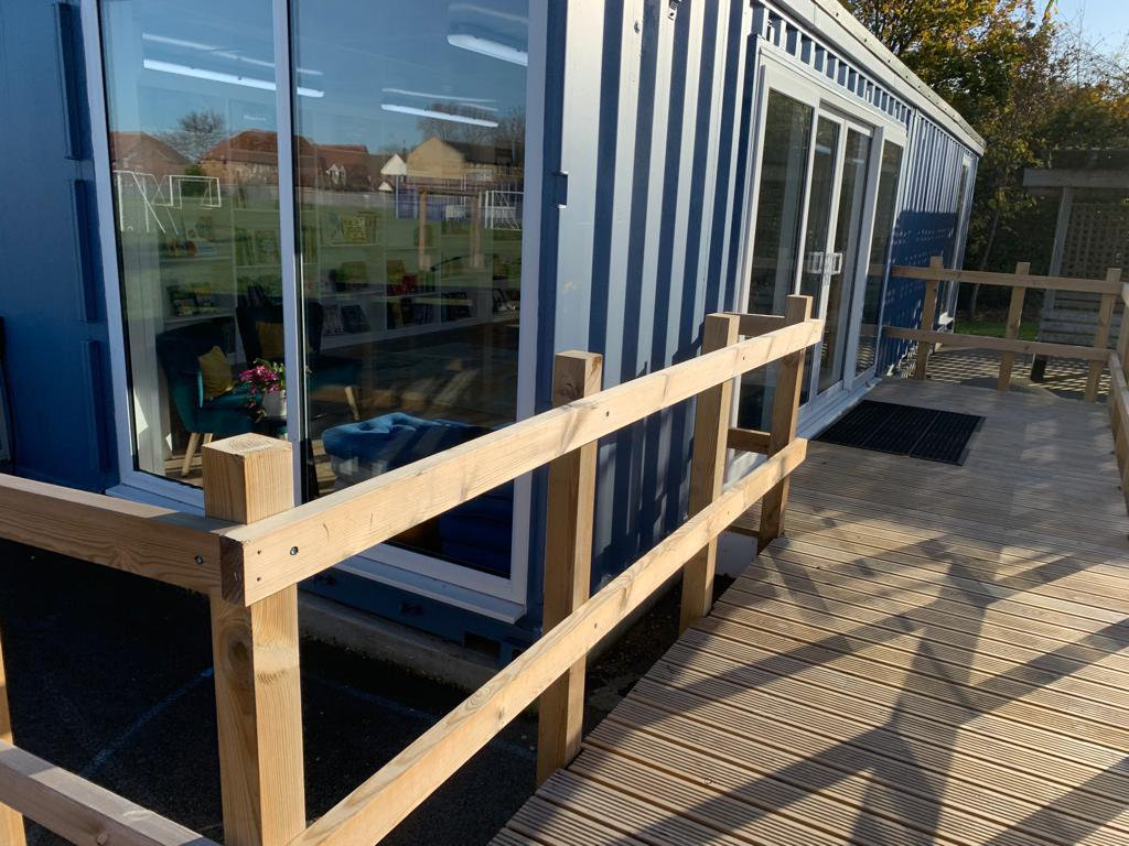 library with decking and hand rail to door